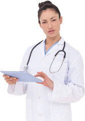 Focused doctor using her tablet pc