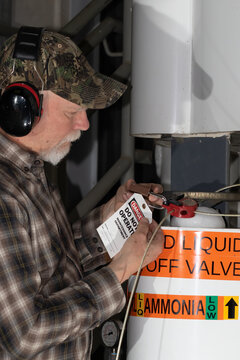 man applying LOTO on ammonia valve