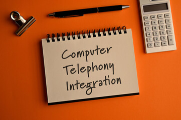 There is a notebook with the word Computer Telephony Integration. It is eye-catching image.