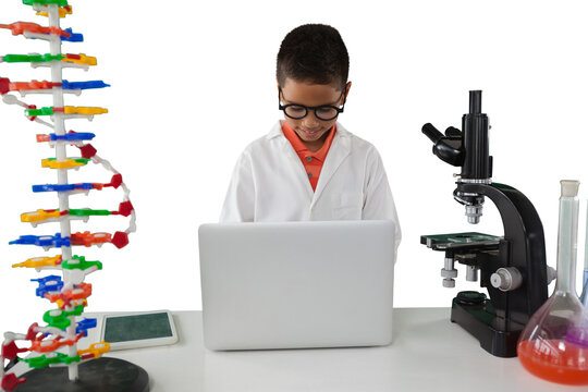 Schoolboy using laptop at desk - Powered by Adobe