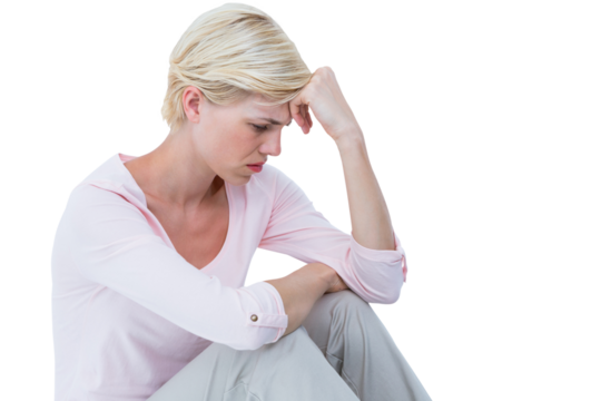 Depressed woman sitting with head in hand