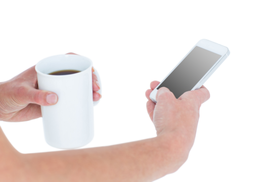 Woman using smartphone while holding coffee
