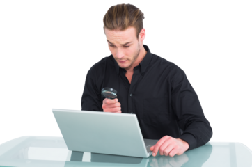 Businessman looking at laptop with magnifying glass