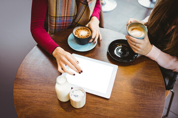Women with digital tablet at cafe