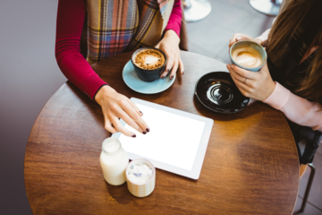 Women with digital tablet at cafe