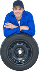 Handsome mechanic leaning on tire