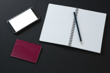 Passport, mobile phone, pencil and organizer on black background