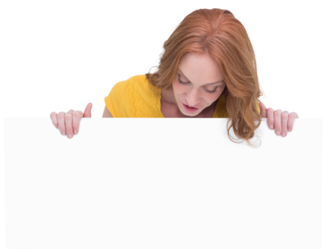 Pretty redhead showing a poster