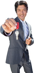 Confident estate agent standing at front door showing key