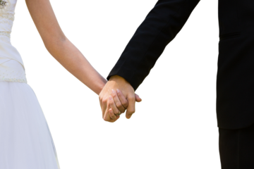 Mid section of newlywed couple holding hands in park