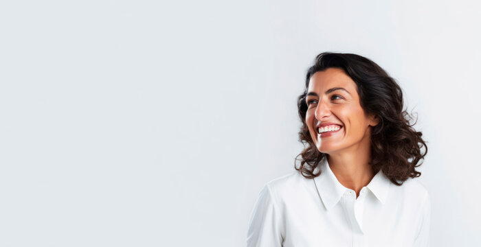 Smiling Happy Woman In Her 40s With Dark Hair And White Shirt On A White Background. Generative AI