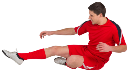 Fit football player jumping and kicking