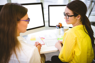 Women looking at each other at office
