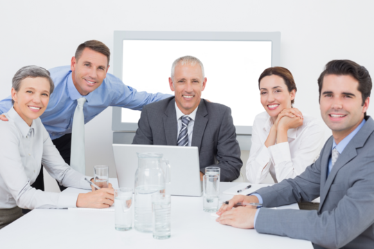 Business team looking at camera