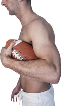 Side view of shirtless rugby player holding ball