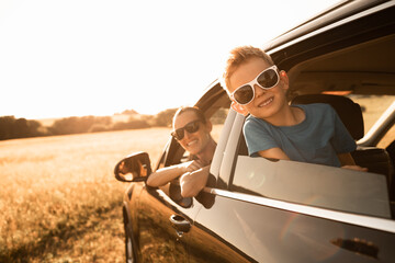 Family road trip. Happy mother and little boy in the car. Family road trip, summer holiday travel. 