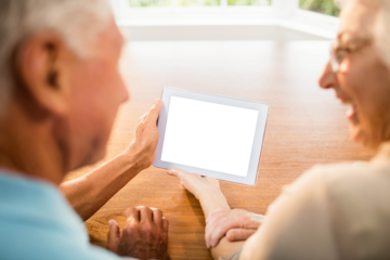 Rear view of senior couple using digital tablet