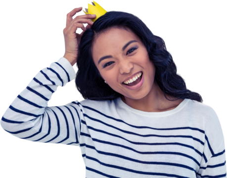 Smiling Asian woman with paper crown - Powered by Adobe