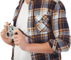Mid section of hipster holding camera
