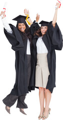 Full length of two women celebrating in the air 