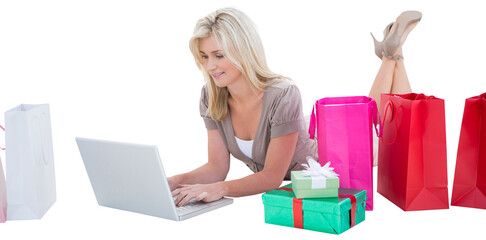 Happy blonde shopping online with laptop