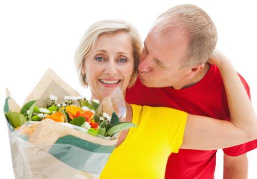 Mature man kissing his partner holding flowers