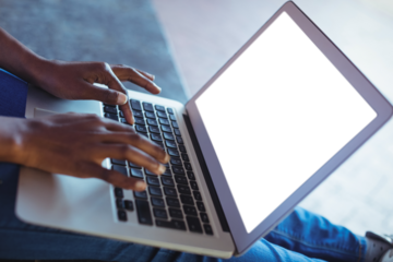 Close-up of schoolgirl using laptop
