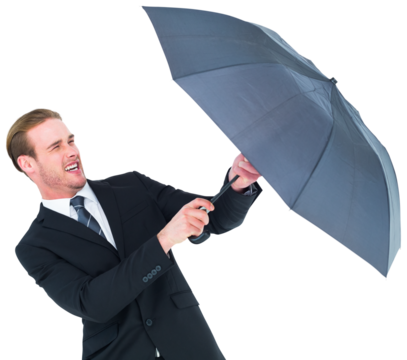 Businessman holding umbrella to protect himself