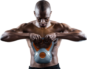 Muscular man looking down while exercising with kettlebell