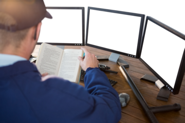 Rear view of security officer reading novel