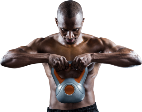 Muscular man looking down while exercising with kettlebell - Powered by Adobe