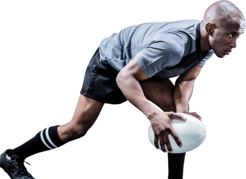 Determined athlete bending while playing rugby
