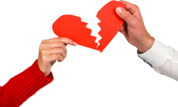 Cropped hands of couple holding cracked red heart shape