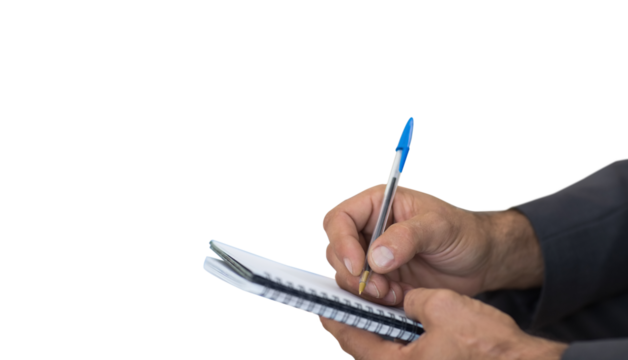 Close up of man writing in spiral book