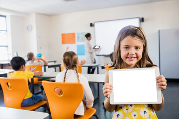 Smiling girl holding standing in classroom