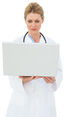 Blonde doctor using laptop