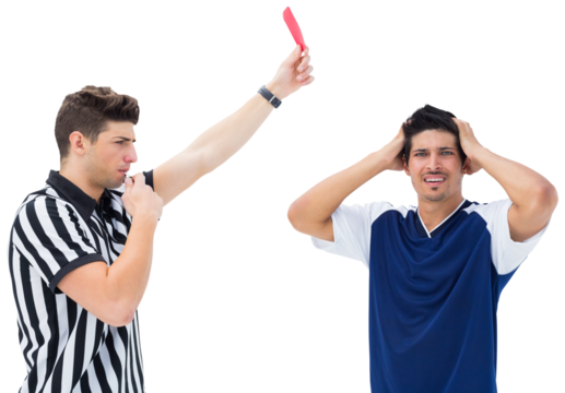 Referee blowing whistle while showing red card to a player