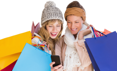 Smiling women with shopping bags looking at mobile phone