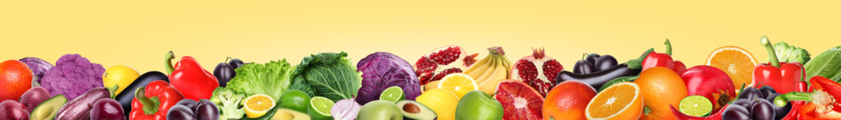 Many different fresh fruits and vegetables on pale light yellow background. Banner design