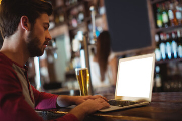 Man using laptop in bar