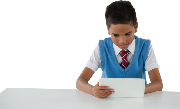 Schoolboy using tablet at table