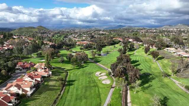 Aerial view of residential neighborhood surrounded by golf and valley during cloudy day in Rancho Bernardo, San Diego County, California. USA. 