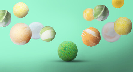 Many different bath bombs falling on pastel turquoise background, banner design