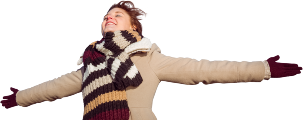 Smiling woman in winter clothes standing arms outstretched