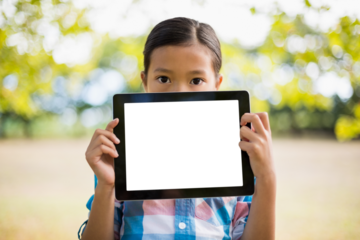 Girl holding digital tablet while standing