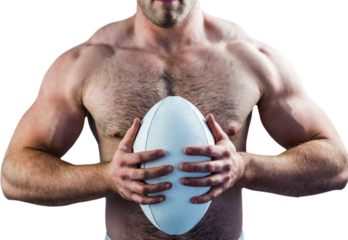 Shirtless rugby player holding ball