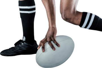 Low section of athlete holding ball while running