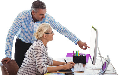Business people discussing over computer at desk