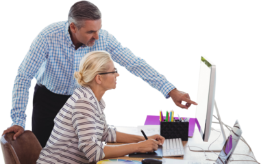 Business people discussing over computer at desk