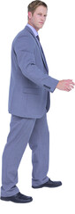 Businessman walking while gesturing with hands 